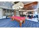 Inviting game room featuring a pool table, foosball table, and comfortable seating area at 231 Riverside Dr # 1801-1, Daytona Beach, FL 32117