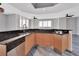 Modern kitchen boasts wood cabinets, black countertops, stainless steel appliances, and a sink overlooking amazing water views at 231 Riverside Dr # 1801-1, Daytona Beach, FL 32117