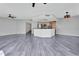 Open floor plan featuring sleek floors, gray walls, multiple ceiling fans, and a modern kitchen at 231 Riverside Dr # 1801-1, Daytona Beach, FL 32117