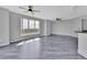 Bright room featuring sleek floors, gray walls, multiple ceiling fans, and a large window with beautiful views at 231 Riverside Dr # 1801-1, Daytona Beach, FL 32117