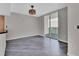 Bright room featuring sleek floors, gray walls, a modern light fixture, and glass sliding doors to a private balcony at 231 Riverside Dr # 1801-1, Daytona Beach, FL 32117