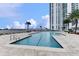 Beautiful pool with lounge chairs and a modern high-rise building in the backdrop at 231 Riverside Dr # 1801-1, Daytona Beach, FL 32117