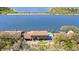 Beautiful aerial view of waterfront property with mature landscaping, pool, and boat dock at 2852 John Anderson Dr, Ormond Beach, FL 32176