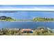 Stunning aerial view of waterfront property with mature trees, pool, dock, and beautiful lake views at 2852 John Anderson Dr, Ormond Beach, FL 32176