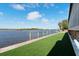 Lush backyard with artificial turf and serene lake views at 2852 John Anderson Dr, Ormond Beach, FL 32176