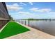 Waterfront backyard with manicured lawn, dock, and stunning views of the water at 2852 John Anderson Dr, Ormond Beach, FL 32176