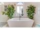 Bathroom highlighting a modern tub, walk-in shower, and decorative accents at 2852 John Anderson Dr, Ormond Beach, FL 32176