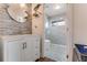 Charming bathroom featuring modern vanity, decorative accent wall, and glass door shower with pebble flooring at 2852 John Anderson Dr, Ormond Beach, FL 32176