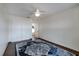 Well-lit bedroom with a ceiling fan, a double door closet, and a colorful rug over wood-look floors at 2852 John Anderson Dr, Ormond Beach, FL 32176