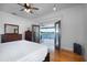 Serene bedroom with water views, hardwood floors, and a ceiling fan at 2852 John Anderson Dr, Ormond Beach, FL 32176