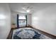 Bright bedroom with a water view window, ceiling fan, and a lovely blue patterned rug over wood-look floors at 2852 John Anderson Dr, Ormond Beach, FL 32176