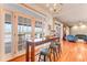 Dining area with waterfront views through French doors and bar seating at 2852 John Anderson Dr, Ormond Beach, FL 32176