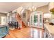 Spacious foyer with hardwood floors, a staircase, and a decorative front door with sidelights at 2852 John Anderson Dr, Ormond Beach, FL 32176