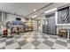 Spacious garage with checkered floors, ample lighting, and tool storage at 2852 John Anderson Dr, Ormond Beach, FL 32176