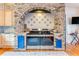 Gourmet kitchen featuring a brick oven alcove, tile backsplash, and stainless steel appliances at 2852 John Anderson Dr, Ormond Beach, FL 32176