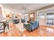 Spacious living room with hardwood floors, a brick fireplace, and access to the back patio at 2852 John Anderson Dr, Ormond Beach, FL 32176