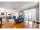 Bright living room with hardwood floors, brick fireplace, and access to the covered patio at 2852 John Anderson Dr, Ormond Beach, FL 32176