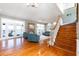 Open-concept living room with hardwood floors, a brick fireplace, and a view of the water at 2852 John Anderson Dr, Ormond Beach, FL 32176