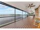 Covered patio featuring ceiling fans, wood flooring, and gorgeous waterfront views at 2852 John Anderson Dr, Ormond Beach, FL 32176