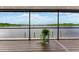 Beautiful water view from a bright room with floor to ceiling windows, and a potted plant at 2852 John Anderson Dr, Ormond Beach, FL 32176