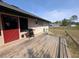 Exterior view of a wooden deck and access to the backyard and the rest of the property at 3141 Branchville Dr, Deltona, FL 32738