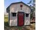 Exterior view of shed with awning covered windows and bright red door at 3141 Branchville Dr, Deltona, FL 32738