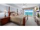 Spacious main bedroom with ocean views and a decorative four poster bed at 3145 S Atlantic Ave # 1004, Daytona Beach Shores, FL 32118