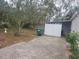 Spacious backyard with a concrete patio, mature trees, and a shed at 333 8Th St, Daytona Beach, FL 32117