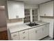 Bright kitchen with white cabinets, stainless steel sink, gray countertops and view out of the window at 333 8Th St, Daytona Beach, FL 32117