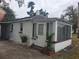 View of the backyard featuring a small concrete patio and white brick exterior walls at 333 8Th St, Daytona Beach, FL 32117
