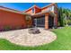 Inviting backyard featuring a screened-in lanai and a custom-built fire pit with brick pavers at 3346 Pegaso Ave, New Smyrna Beach, FL 32168