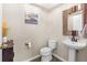 Charming powder room with pedestal sink, decorative mirror, and neutral decor at 3346 Pegaso Ave, New Smyrna Beach, FL 32168