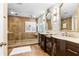 An elegant bathroom featuring dual vanities, stone accent walls, and a luxurious walk-in shower at 3346 Pegaso Ave, New Smyrna Beach, FL 32168