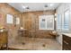 Luxury bathroom boasting a glass-enclosed shower with a tiled bench, stone accents and multiple shower heads at 3346 Pegaso Ave, New Smyrna Beach, FL 32168