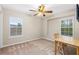 Bright bedroom featuring large windows that allow natural light to illuminate the room, and neutral carpet at 3346 Pegaso Ave, New Smyrna Beach, FL 32168