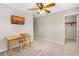 Bright bedroom featuring a ceiling fan, a flat-screen TV, and a cozy study area with lots of space at 3346 Pegaso Ave, New Smyrna Beach, FL 32168