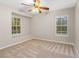 Bright bedroom features a ceiling fan, windows and a cozy alcove perfect for relaxing and enjoying views at 3346 Pegaso Ave, New Smyrna Beach, FL 32168