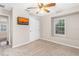 Bedroom features a ceiling fan, flat-screen TV, a closet, and a bright window providing natural light and views at 3346 Pegaso Ave, New Smyrna Beach, FL 32168