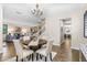 Lovely dining area open to the living spaces, bathed in natural light and features a contemporary chandelier at 3346 Pegaso Ave, New Smyrna Beach, FL 32168