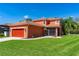 Charming home with an attached garage, lush lawn, a screened-in patio, and beautiful landscaping at 3346 Pegaso Ave, New Smyrna Beach, FL 32168