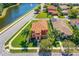 Stunning two-story home featuring vibrant landscaping, a terracotta roof, and situated on a corner lot at 3346 Pegaso Ave, New Smyrna Beach, FL 32168