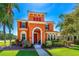 Inviting Mediterranean-style home with vibrant colors, lush landscaping and a well-manicured lawn at 3346 Pegaso Ave, New Smyrna Beach, FL 32168