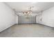 Clean and spacious garage with a freshly painted white cinder block wall and epoxy flooring at 3346 Pegaso Ave, New Smyrna Beach, FL 32168