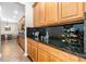 Gourmet kitchen featuring maple cabinetry, granite countertops, stainless steel appliances, tile flooring and wine rack at 3346 Pegaso Ave, New Smyrna Beach, FL 32168