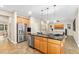 Gourmet kitchen featuring wood cabinets, stainless steel appliances, granite counters and a view to the living room at 3346 Pegaso Ave, New Smyrna Beach, FL 32168