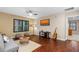 Inviting living room with hardwood floors, modern decor, and natural light from a large window at 3346 Pegaso Ave, New Smyrna Beach, FL 32168
