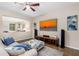 Relaxing living room with a mounted television, ceiling fan and comfortable seating arrangement at 3346 Pegaso Ave, New Smyrna Beach, FL 32168
