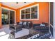 Relaxing patio with stylish wicker furniture, a ceiling fan, and direct access from sliding glass doors at 3346 Pegaso Ave, New Smyrna Beach, FL 32168