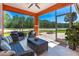 Tranquil screened porch with wicker furniture and a picturesque view of the backyard and beyond at 3346 Pegaso Ave, New Smyrna Beach, FL 32168