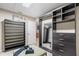 Spacious walk-in closet features custom shelves, drawers, a full-length mirror, and an inviting seating area at 3346 Pegaso Ave, New Smyrna Beach, FL 32168